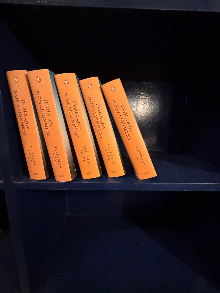 Five copies of India after Nonalignment on a navy bookshelf