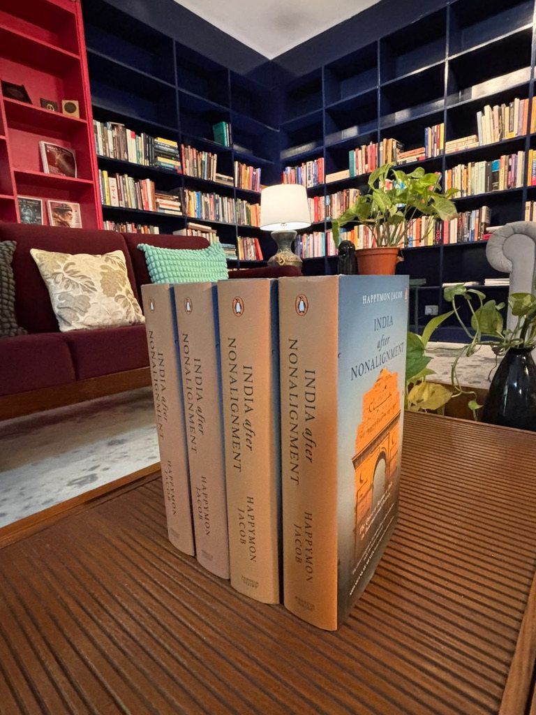 Copies of India after Nonalignment standing on a table in front of bookshelves